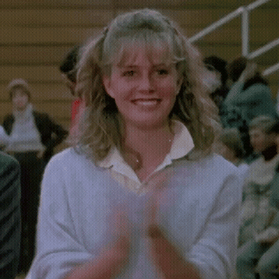 Woman Smiling And Clapping In Front Of Crowd GIF