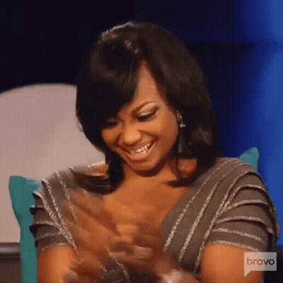 Woman Smiling And Clapping On Couch GIF