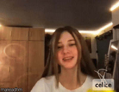 Woman Smiling And Looking At Camera In Living Room GIF