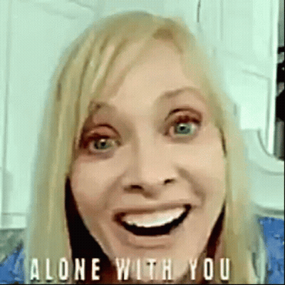 Woman Smiling And Making Funny Face Saying Alone With You GIF