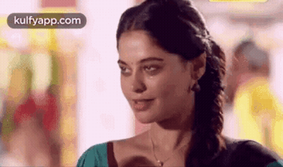 Woman Smiling At Camera Wearing Necklace And Earrings GIF