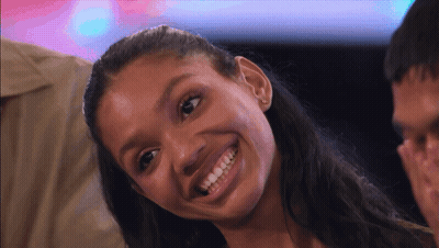 Woman Smiling At Camera With Man Behind GIF