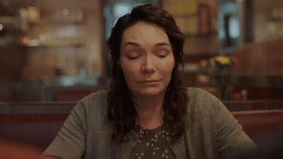 Woman Smiling At Diner Table GIF