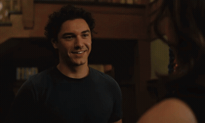 Woman Smiling At Man Wearing Necklace GIF