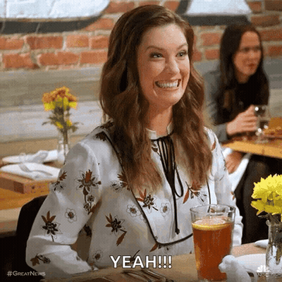Woman Smiling At Table With Beer And Wine GIF