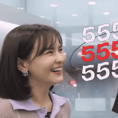 Woman Smiling Beside Sign 555 555 555 555 GIF