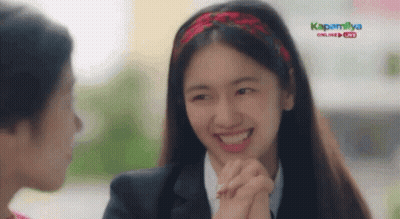 Woman Smiling Holding Another Woman's Hand in Front of Kapamilya Online Live Screen