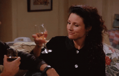 Woman Smiling Holding Glass Of Wine GIF