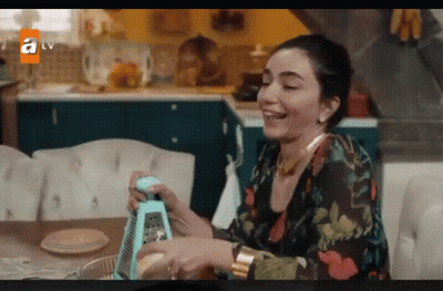 Woman Smiling Holding Grater In Kitchen GIF