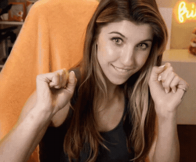Woman Smiling Holding Hands Near Neon Sign Bi GIF