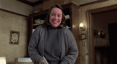 Woman Smiling Holding Knife In Living Room GIF