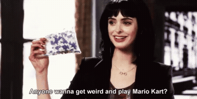 Woman Smiling Holding Paper Saying Anyone Wanna Get Weird and Play Mario Kart