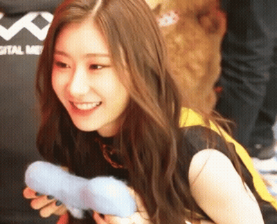 Woman Smiling Holding Toy In Front Of Digital Me Shirt GIF