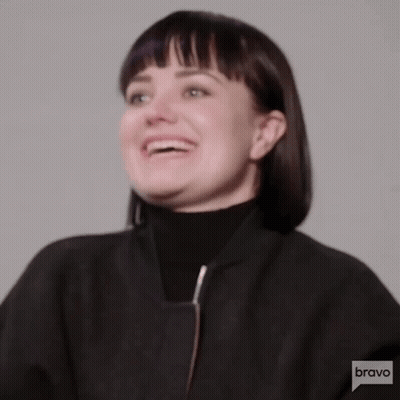 Woman Smiling In Black Jacket And Turtleneck GIF