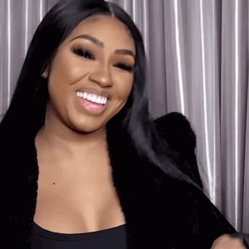 Woman Smiling In Black Top And Jacket GIF