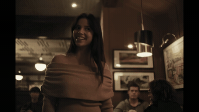 Woman Smiling In Dark Room GIF