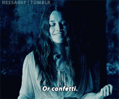 Woman Smiling In Dark Room Saying Confetti GIF