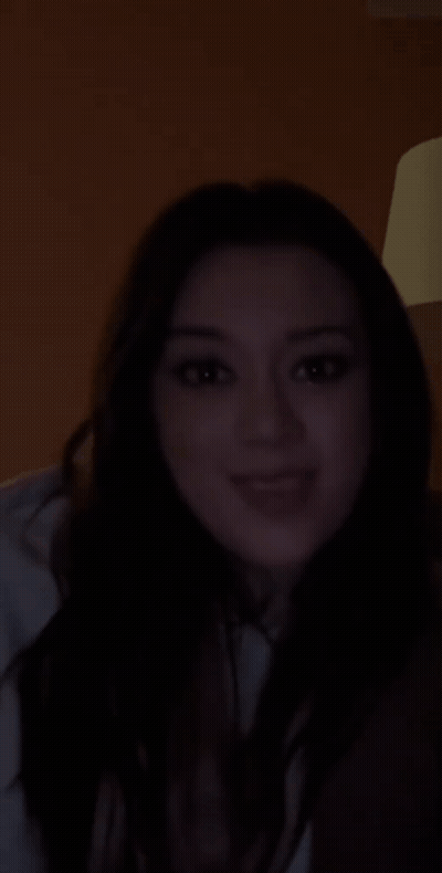 Woman Smiling In Dark Room GIF