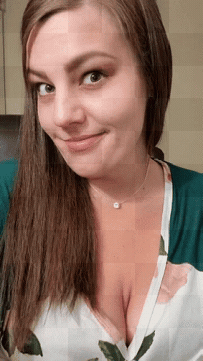 Woman Smiling In Floral Shirt And Necklace GIF