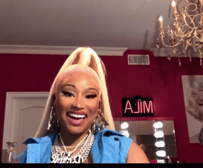 Woman Smiling In Front Of AJM Sign GIF