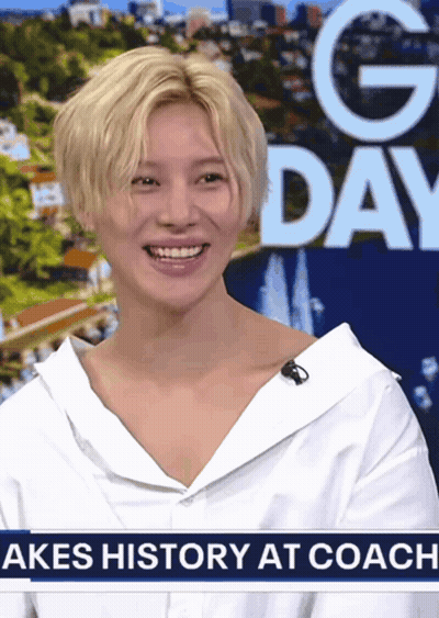 Woman Smiling In Front Of Akes History At Coach Sign GIF