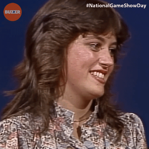 Woman Smiling In Front Of Blue Background Buzzr Logo GIF