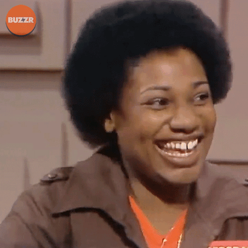 Woman Smiling In Front Of Buzzr Logo GIF