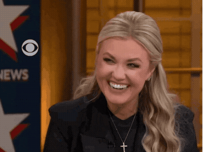Woman Smiling in Front of CBS News Sign