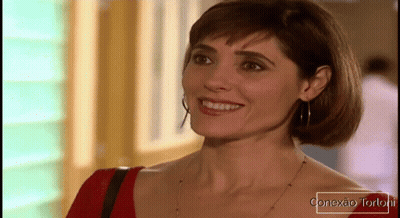 Woman Smiling In Front Of Conexao Tortoril Sign GIF
