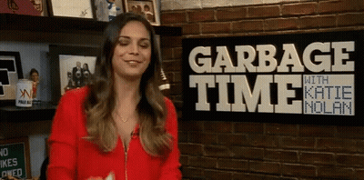 Woman Smiling In Front Of Garbage Time Sign GIF