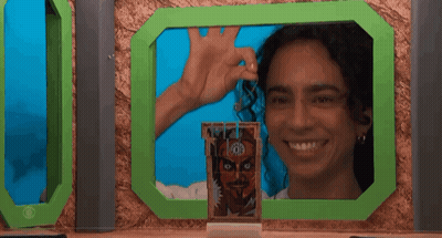 Woman Smiling In Front Of Green Frame With Man Picture GIF