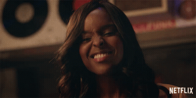 Woman Smiling In Front Of Netflix Sign GIF