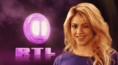 Woman Smiling In Front Of Purple RTL Logo GIF