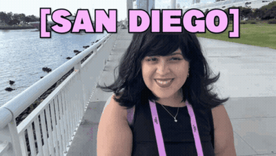 Woman Smiling In Front Of San Diego Sign GIF