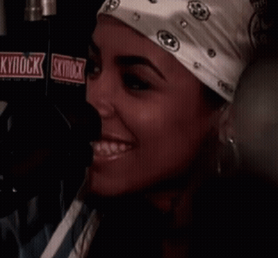 Woman Smiling in Front of Skyrock Microphone