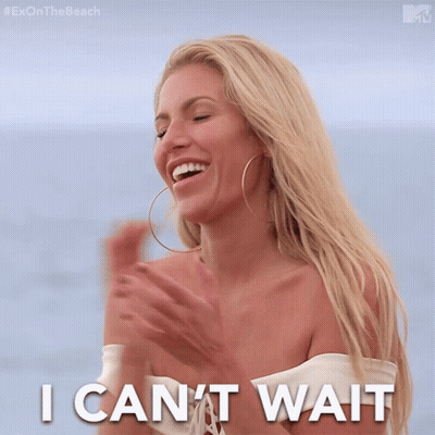 Woman Smiling In Front Of Toy Shelf GIF