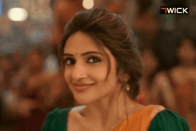 Woman Smiling In Front Of Wick Sign GIF