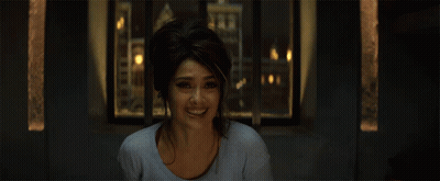 Woman Smiling In Front Of Window With City Background GIF