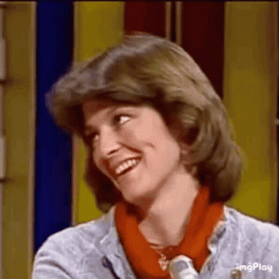 Woman Smiling In Front Of Yellow Wall GIF