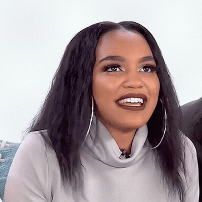 Woman Smiling In Grey Turtleneck And Hoop Earrings GIF