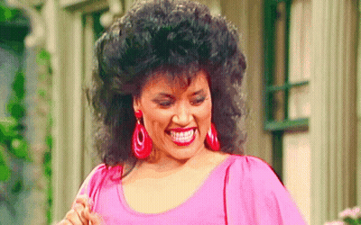 Woman Smiling In Pink Top And Red Earrings GIF