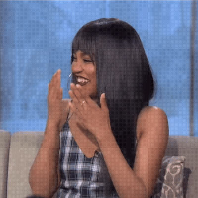 Woman Smiling In Plaid Top And Earrings GIF