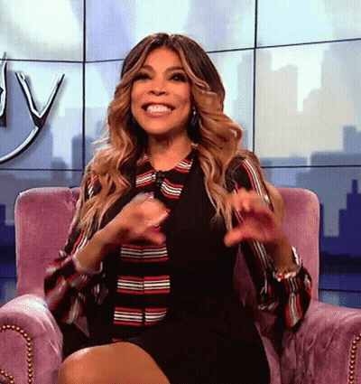 Woman Smiling In Purple Chair Legs Crossed GIF