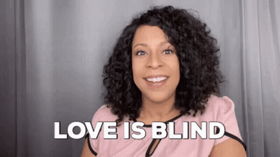Woman Smiling Saying Love Is Blind In Pink Shirt GIF