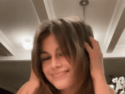 Woman Smiling Touching Her Hair GIF