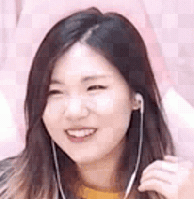 Woman Smiling Wearing Earbuds GIF