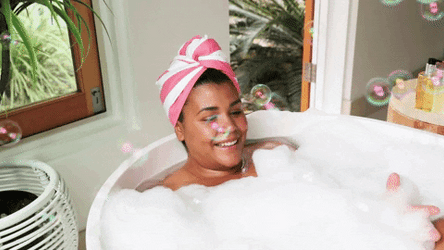 Woman Smiling While Enjoying Bubble Bath GIF