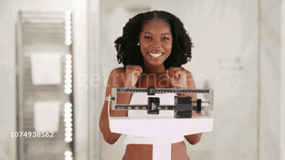 Woman Smiling While Standing On Scale GIF