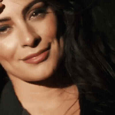 Woman Smiling With Hand On Forehead GIF