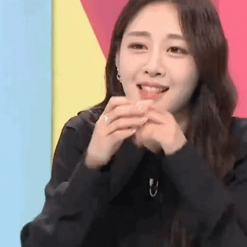 Woman Smiling With Hands Folded GIF